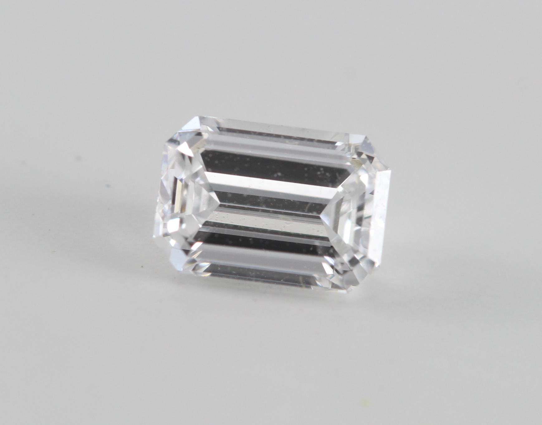 An emerald-cut loose diamond (0.57 Ct Ct, D Color, VVS2 Clarity, WGI Certified) for sale online at CaratsDirect2u.com.